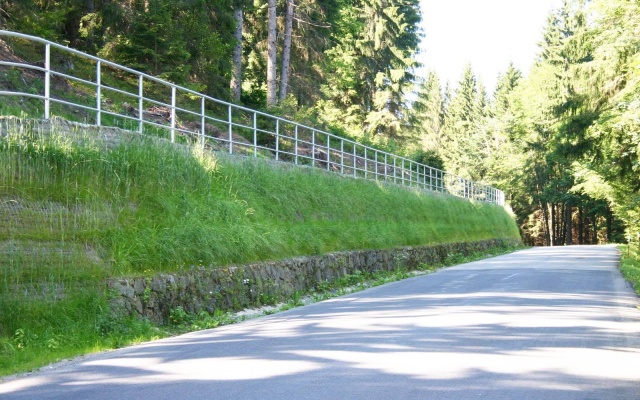 Výškové oddelenie cesty a cyklotrasy strmým svahom v Prášilech na Šumave